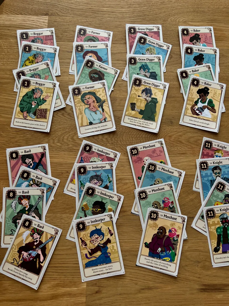 All the Crown Shuffle character cards laid out in rows on a wooden table